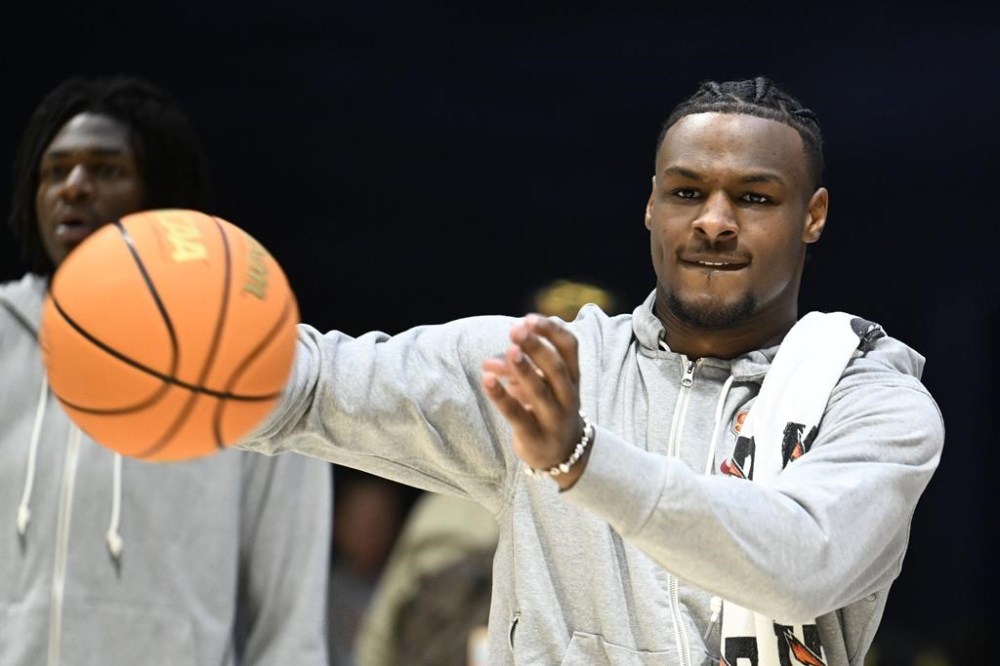 Southern California guard Bronny James joins teammates on the court during warmups for an NCAA college basketball game against Seton Hall on Thursday, Nov. 23, 2023, in San Diego. James suffered a cardiac arrest in July. (AP Photo/Denis Poroy)
