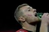 A red mark is painted on the face of AC Milan's Tommaso Pobega to promote International Day for the Elimination of Violence against Women during a Serie A soccer match between AC Milan and Fiorentina, at the San Siro stadium in Milan, Italy, Saturday, Nov. 25, 2023. (AP Photo/Luca Bruno)