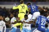 Marseille's goalkeeper Pau Lopez, left, and Strasbourg's Gerzino Nyamsi compete for the ball during a French League One soccer match between Strasbourg and Olympique de Marseille at Stade de la Meinau stadium in Strasbourg, France, Saturday, Nov. 25, 2023. (AP Photo/Jean-Francois Badias)