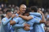 Manchester City's Erling Haaland, centre, celebrates with teammates after scoring his side's opening goal during the English Premier League soccer match between Manchester City and Liverpool at Etihad stadium in Manchester, England, Saturday, Nov. 25, 2023. (AP Photo/Rui Vieira)