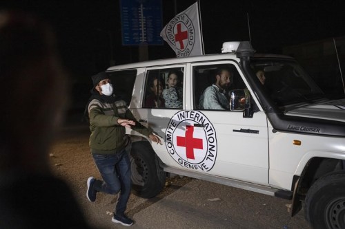 A Red Cross vehicle carrying Israeli hostages drives by at the Gaza Strip crossing into Egypt in Rafah on Saturday, Nov. 25, 2023. Jewish and Muslim groups in Canada say they are closely following the ongoing ceasefire between Israel and Hamas. THE CANADIAN PRESS/AP/Fatima Shbair