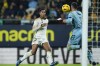Real Madrid's Jude Bellingham, left, looks on as Cadiz's goalkeeper Jeremias Ledesma catches the ball during Spanish La Liga soccer match between Cadiz FC and Real Madrid at the Nuevo Mirandilla stadium in Cadiz, Spain, Sunday, Nov. 26, 2023. (AP Photo/Jose Breton)