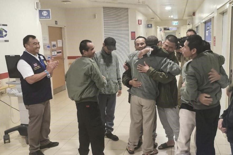 In this photo provided by Thailand's Foreign Ministry, Thai hostages, who were previously released, hug their newly freed compatriots at the Shamir Medical Center in Israel on Sunday, Nov. 26, 2023. Hamas freed several Thai nationals seized in the group's surprise attack on southern Israel last month, releasing them alongside Israeli hostages under a cease-fire deal. (Thailand's Foreign Ministry via AP )