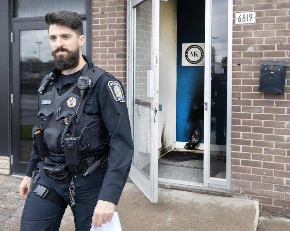 A police officer leaves from the entrance of a Jewish community centre Monday, Nov. 27, 2023, in Montreal. Montreal police are investigating after an incendiary object was allegedly thrown against the door of a Jewish community centre early this morning. THE CANADIAN PRESS/Ryan Remiorz