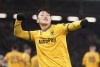 Wolverhampton Wanderers' Hwang Hee-Chan celebrates scoring during the Premier League soccer match between Wolverhampton Wanderers and Fulham at Craven Cottage, London, Monday Nov. 27, 2023. (Zac Goodwin/PA via AP)