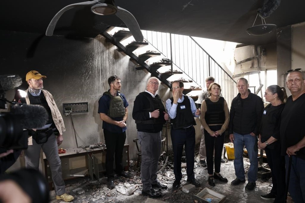 Israel's President Isaac Herzog, center right, and German President Frank-Walter Steinmeier, center leftt, visit Kibbutz Beeri in southern Israel, Monday, Nov. 27, 2023. (Ronen Zvulun/Pool Photo via AP)