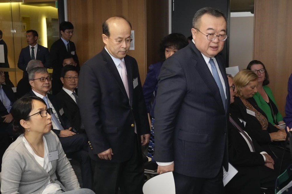 Liu Jianchao, right, Minister of the International Department of the Central Committee of the Communist Party of China, walks with the Chinese ambassador to Australia, Xiao Qian ahead of his address at University of Technology Sydney, in Sydney, Australia, Tuesday, Nov. 28, 2023. (AP Photo/Mark Baker)