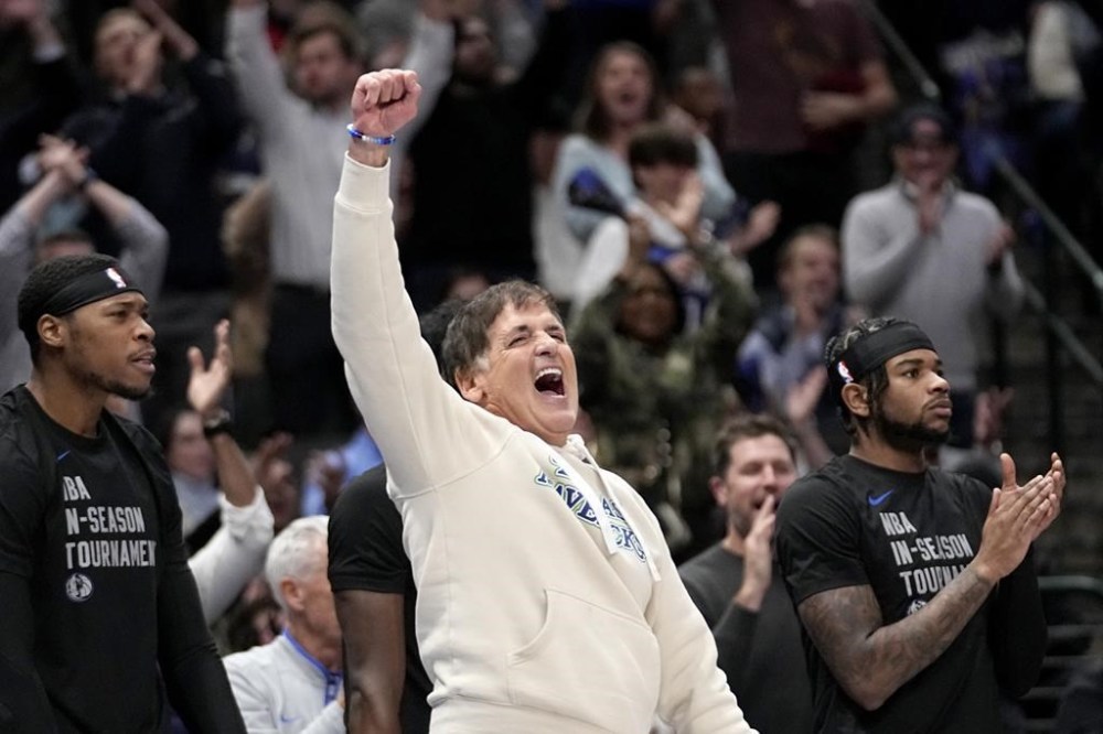 Dallas Mavericks team owner Mark Cuban celebrates late in the second half of an NBA basketball game against the Houston Rockets in Dallas, Tuesday, Nov. 28, 2023. (AP Photo/Tony Gutierrez)