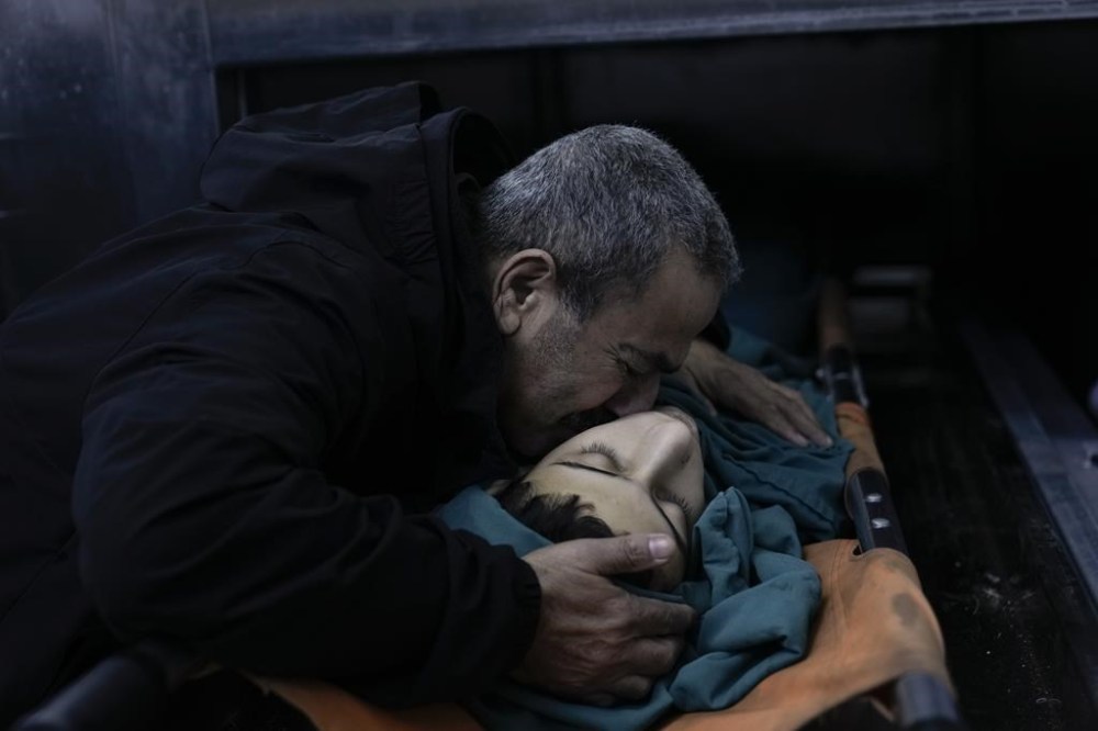 A relative mourns 15-year-old Basil Abu Al-Wafa, who was killed during an Israeli military raid on Jenin refugee camp in the West Bank on Wednesday, Nov. 29, 2023. (AP Photo/Majdi Mohammed)