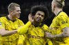 Dortmund's Karim Adeyemi, center, celebrates with his teammates after scoring his side's third goal during the Champions League group F soccer match between AC Milan and Borussia Dortmund at the San Siro stadium in Milan, Italy, Tuesday, Nov. 28, 2023. (AP Photo/Antonio Calanni)
