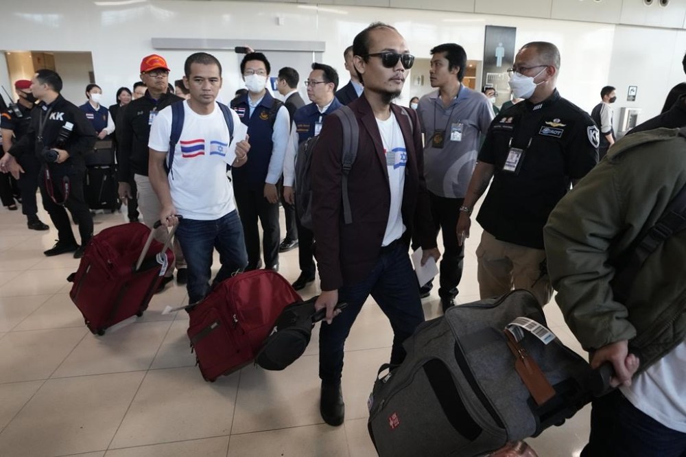 Thai hostages who were freed from Hamas arrive at Suvarnabhumi International Airport in Samut Prakarn Province, Thailand, Thursday, Nov. 30, 2023. Twenty-three Thai hostages kidnapped by Hamas in its Oct. 7, 2023 attack on southern Israel have been freed so far, and Thailand's foreign ministry says nine remain in captivity in Gaza. There were about 30,000 Thai overseas workers in Israel, mostly in the agricultural sector, but more than 8,000 have returned home since the attack. (AP Photo/Sakchai Lalit)