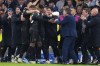 Napoli's Andre-Frank Zambo Anguissa, centre left, celebrates with teammates after scoring his side's second goal during the Champions League Group C soccer match between Real Madrid and Napoli at the Santiago Bernabeu stadium in Madrid, Spain, Wednesday, Nov. 29, 2023. (AP Photo/Manu Fernandez)