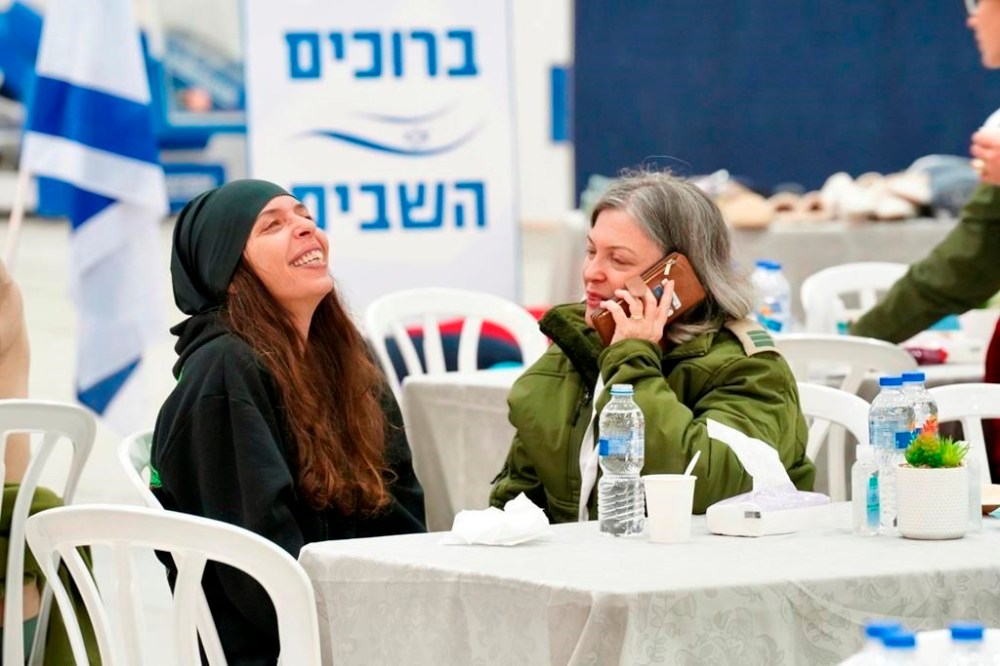 This handout photo provided by the IDF on Thursday, Nov. 30, 2023, shows released Israeli hostage Moran Stela Yanai, left, upon her arrival at Hatzerim military base in Israel, after being held hostage by militant group Hamas in the Gaza Strip. Moran Stela Yanai was released on Wednesday, Nov. 29, 2023. (IDF via AP)