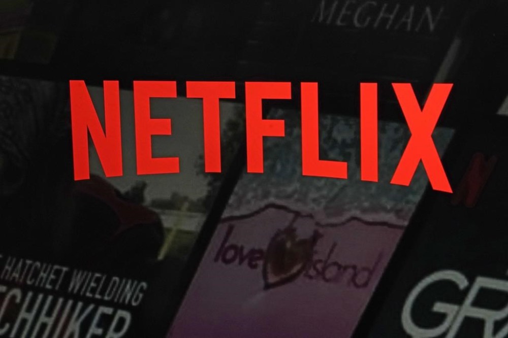 Streaming giant Netflix says the federal broadcasting regulator should recognize the role it plays in helping fund Canada's broadcasting industry and reject calls to impose an additional mandatory payment from the company. The Netflix logo is displayed on the company's website, Feb. 2, 2023, in New York. THE CANADIAN PRESS/AP-Richard Drew