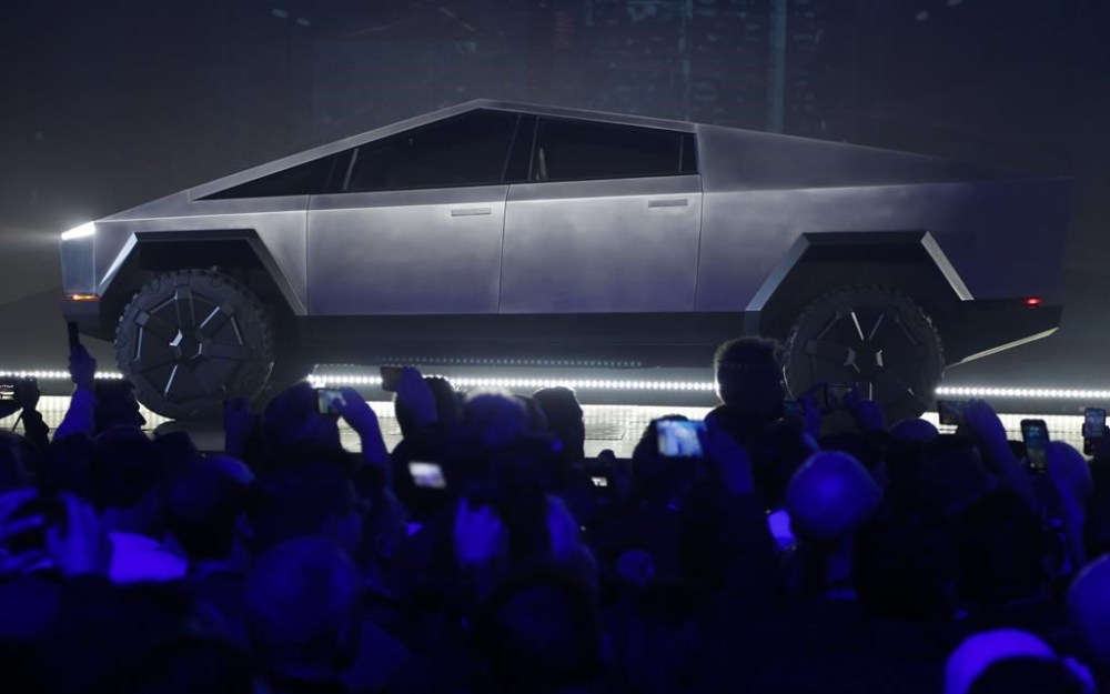File - The Tesla Cybertruck is unveiled at Tesla's design studio on Nov. 21, 2019, in Hawthorne, Calif. Tesla CEO Elon Musk is expected to give an update on manufacturing problems with long-awaited Cybertruck at an event Thursday marking the first deliveries of the futuristic, angular pickup truck. (AP Photo/Ringo H.W. Chiu, File)