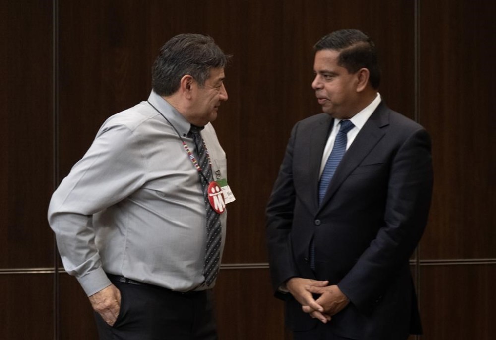 Minister of Crown-Indigenous Relations Gary Anandasangaree speaks with Metis Settlement General Council President Dave Larouche as he waits to appear before the Indigenous and Northern Affairs committee, Thursday, November 30, 2023 in Ottawa. THE CANADIAN PRESS/Adrian Wyld