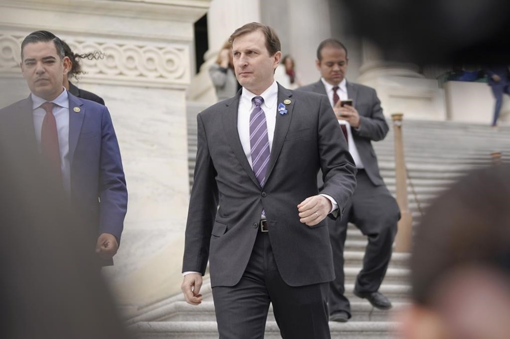 Rep. Dan Goldman, D-N.Y., center, leaves the Capitol after Rep. George Santos, R-N.Y., was expelled from the House of Representatives, Friday, Dec. 1, 2023, in Washington. The House has voted to expel Santos following a critical ethics report on his conduct that included converting campaign donations for his own use, making him just the sixth member in the chamber's history to be ousted by his colleagues. Expulsion requires support from two-third of the House. (AP Photo/Mariam Zuhaib)