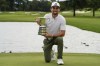 Chile's Joaquin Niemann holds the trophy after winning the Australian Open Golf Championship at the Australian Golf Club in Sydney, Australia, Sunday, Dec. 3, 2023. (AP Photo/Mark Baker)
