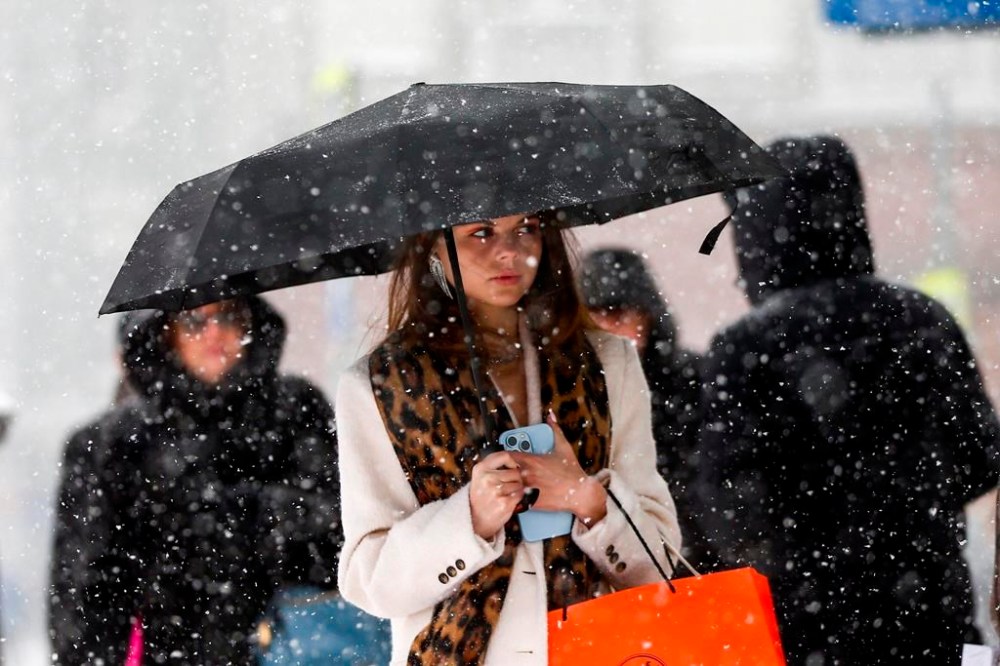 A woman walks down a street during heavy snowfall in Moscow, Russia, Sunday, Dec. 3, 2023. A record snowfall has hit Russia's capital bringing an additional 10 cm to already high levels of snow and causing disruption at the capital's airports and on roads. (Sergei Vedyashkin/Moscow News Agency via AP)