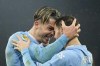 Manchester City's Jack Grealish celebrates with Bernardo Silva, right, after scoring his side's third goal during the English Premier League soccer match between Manchester City and Tottenham Hotspur at Etihad stadium in Manchester, England, Sunday, Dec. 3, 2023. (AP Photo/Dave Thompson)