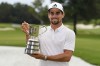 Chile's Joaquin Niemann holds the trophy after winning the Australian Open Golf Championship at the Australian Golf Club in Sydney, Australia, Sunday, Dec. 3, 2023. (AP Photo/Mark Baker)