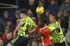 CAPTION CORRECTS THE DATE- Luton Town's Gabriel Osho, center, duels for the ball with Arsenal's William Saliba, right, and Arsenal's Declan Rice during the English Premier League soccer match between Luton and Arsenal at Kenilworth Road, Luton, England, Tuesday, Dec. 5, 2023. (AP Photo/Ian Walton)