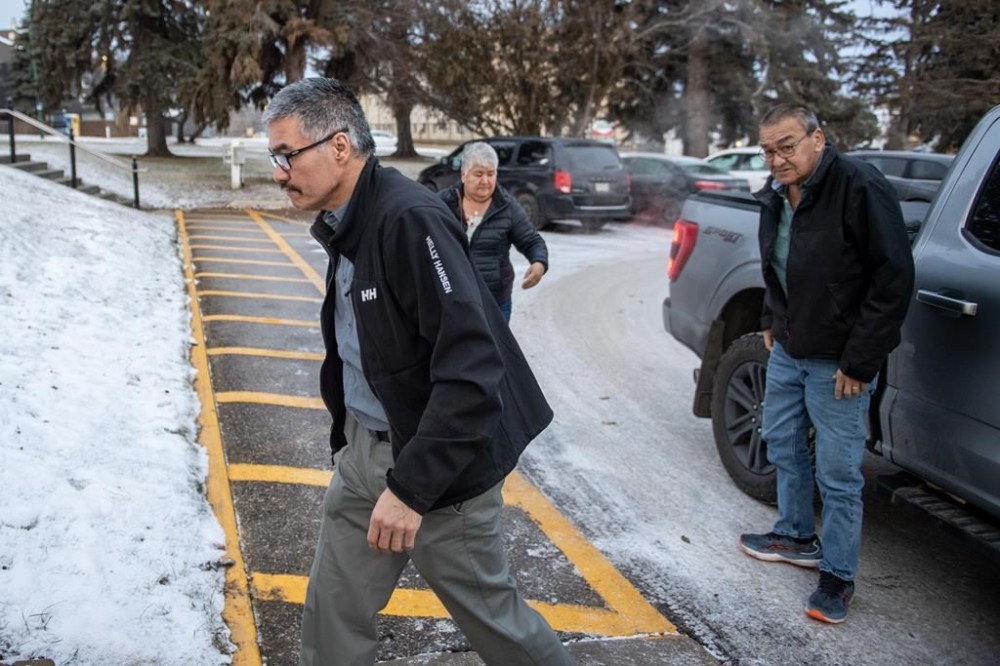 Former RCMP officer Bernie Herman, left, enters the Court of King’s Bench on the second day of his trial in Prince Albert, Sask., on Tuesday, Dec. 5, 2023. The first-degree murder trial is set to hear information about an autopsy on Wednesday. THE CANADIAN PRESS/Liam Richards