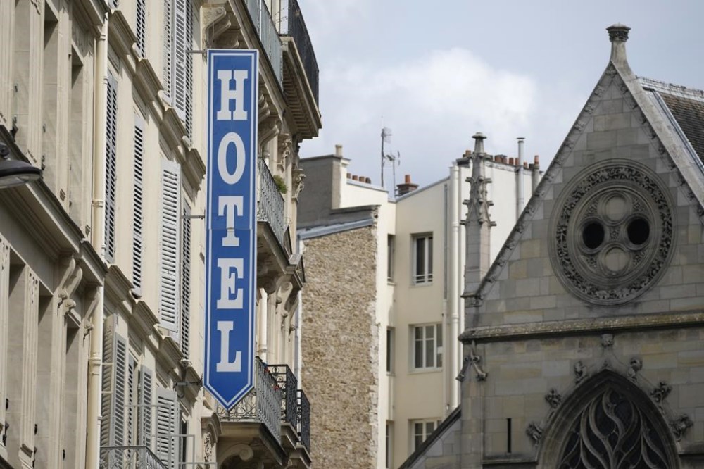 FILE - A sign advertising an hotel is pictured in Paris Thursday, July 20, 2023. French authorities will carry out checks at 10,000 hotels and restaurants across France ahead of the Paris Olympics next year in order to limit expected massive price hikes during the Games. (AP Photo/Christophe Ena, File)