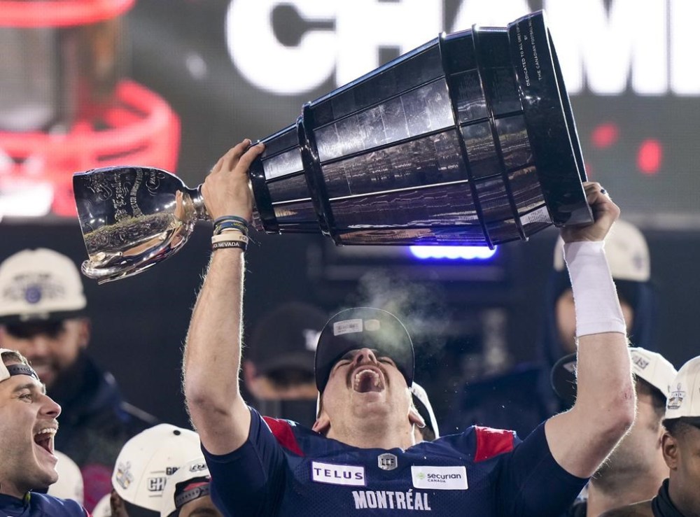 Montreal Alouettes quarterback Cody Fajardo (7) hoists the Grey Cup as the Alouettes celebrate defeating the Winnipeg Blue Bombers in the 110th CFL Grey Cup in Hamilton, Ont., on Sunday, November 19, 2023. The Grey Cup champion Montreal Alouettes have extended the contract of Fajardo through the 2025 CFL season. THE CANADIAN PRESS/Frank Gunn