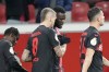 Leverkusen's Victor Boniface, 2nd from right, shakes hand with Leverkusen's Robert Andrich after he scored the opening goal during the German Soccer Cup round of 16 match between Bayer Leverkusen and SC Paderborn at the BayArena in Leverkusen, Germany, Wednesday, Dec. 6, 2023. (AP Photo/Martin Meissner)
