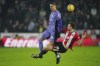 Liverpool's Darwin Nunez, left, battles for the ball with Sheffield United's Jack Robinson during the English Premier League soccer match between Sheffield United and Liverpool at Bramall Lane in Sheffield, England, Wednesday, Dec. 6, 2023. (AP Photo/Jon Super)
