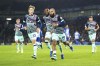 Brentford's Bryan Mbeumo, center, celebrates scoring their side's first goal of the game during their English Premier League soccer match at the American Express Stadium, Brighton and Hove, England, Wednesday, Dec. 6 2023. (Adam Davy/PA via AP)