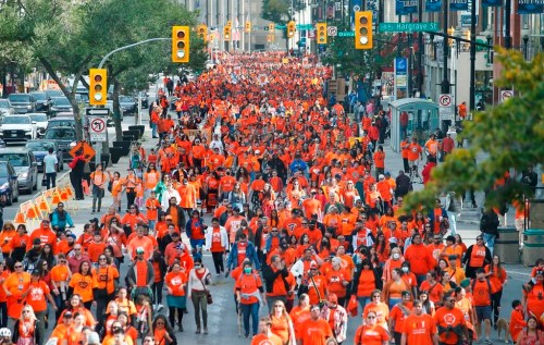 People attend the second annual Orange Shirt Day Survivors Walk and Pow Wow on National Day for Truth and Reconciliation in Winnipeg on Friday, Sept. 30, 2022. A bill to make Orange Shirt day a statutory holiday in Manitoba has passed its final vote in the legislature. THE CANADIAN PRESS/John Woods