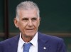 FILE - Iran's head coach Carlos Queiroz looks out before the World Cup group B soccer match between England and Iran at the Khalifa International Stadium in Doha, Qatar, Monday, Nov. 21, 2022. Carlos Queiroz was fired as Qatar's head coach just over a month before the nation hosts the Asian Cup. Queiroz, former coach of Real Madrid, Portugal and Iran, was appointed on a four-year contract in February 2023, after Felix Sanchez left the position. (AP Photo/Frank Augstein, File)