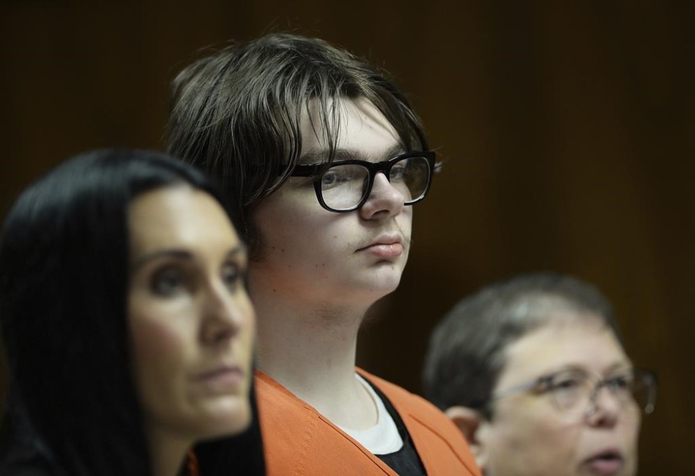 FILE - Ethan Crumbley stands with his attorneys, Paulette Loftin and Amy Hopp, during his hearing at Oakland County Circuit Court, Aug. 1, 2023, in Pontiac, Mich. Crumbley, who killed four other students at a Michigan school will listen to their families and survivors of the mass shooting before a judge decides whether the attack will carry a life prison sentence on Friday, Dec. 8, 2023. (Clarence Tabb Jr./Detroit News via AP, Pool, File)