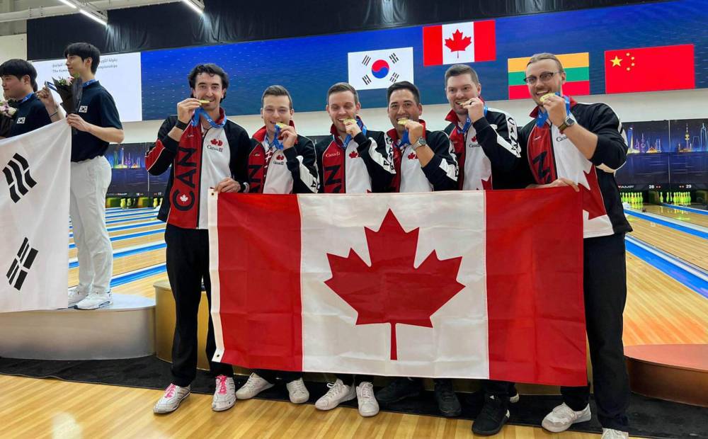 Austyn Ducharme (far left) and Mitch Hupe (extreme right) celebrate team gold in Salmiya, Kuwait back in October. (Supplied)