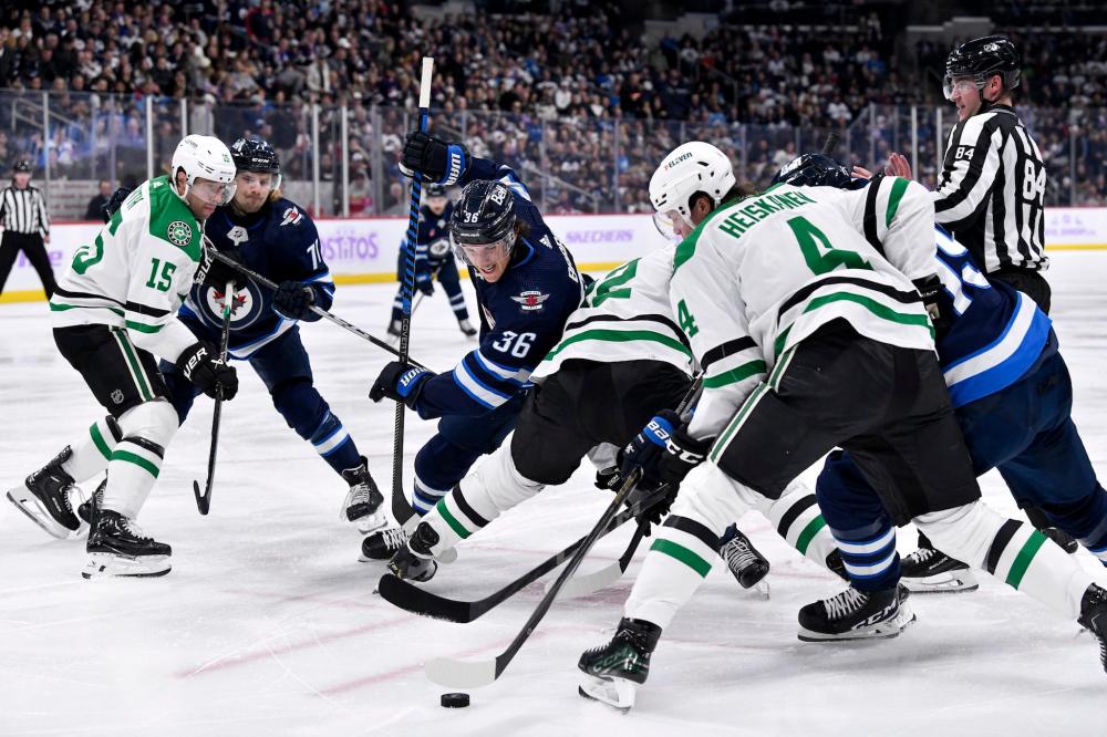 THE CANADIAN PRESS/Fred Greenslade
Dallas Stars' Miro Heiskanen and Winnipeg Jets' Morgan Barron battle for the puck after a face-off during the second period.