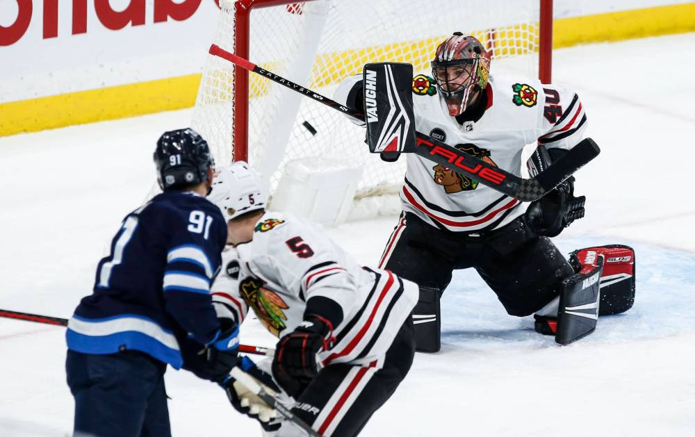 JOHN WOODS / THE CANADIAN PRESS

Jets forward Cole Perfetti (91) snipes on Blackhawks goaltender Arvid Soderblom while Chicago’s Connor Murphy (5) defends during the third period.