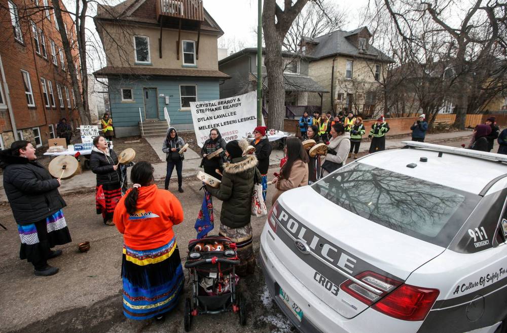 The Sunday vigil at the Langside Street home was organized by the Bear Clan to honour the victims of the November 26 shooting. (John Woods / Winnipeg Free Press)