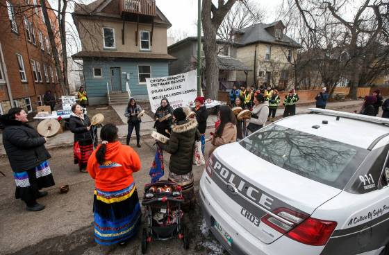 The Sunday vigil at the Langside Street home was organized by the Bear Clan to honour the victims of the Nov. 26 shooting. (John Woods / Winnipeg Free Press)
