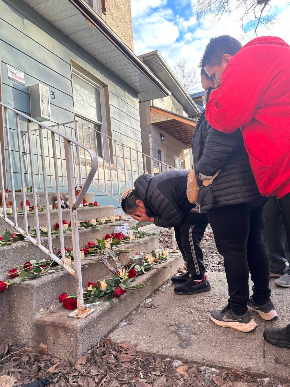 Beverley Beardy takes in the memorial at the site of a shooting last weekend that claimed the lives of her two daughters, Crystal and Stephanie Beardy. A vigil for the four people killed in the shooting was held Sunday afternoon. (Katrina Clarke / Winnipeg Free Press)