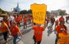 People march past the Canadian Museum for Human Rights as they attend the second annual Orange Shirt Day walk and powwow on National Day for Truth and Reconciliation in Winnipeg on Friday. (John Woods / The Canadian Press files)