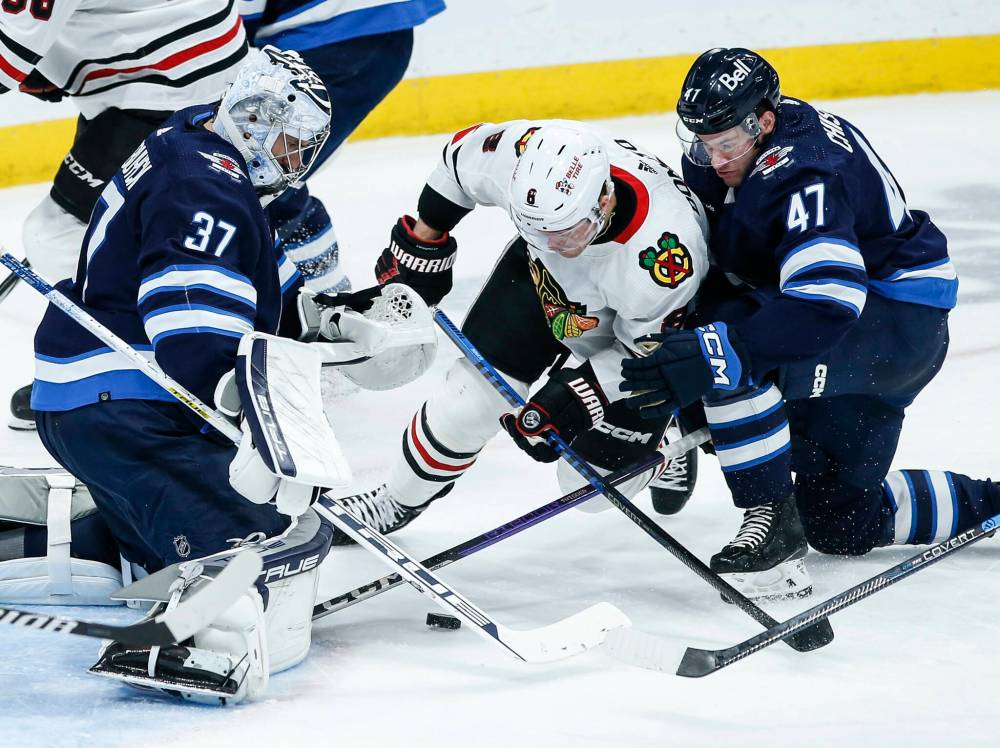 John Woods / THE CANADIAN PRESS
Declan Chisholm (right) hasn’t looked out of place patrolling the blue line for the Winnipeg Jets in their games against the Chicago Blackhawks and the Carolina Hurricanes.