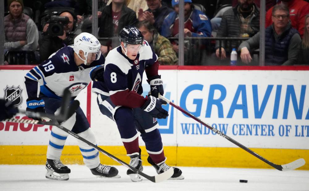 (AP Photo/David Zalubowski)
Colorado Avalanche defenceman Cale Makar, right, collects the puck next to Winnipeg Jets centre David Gustafsson during the first period.