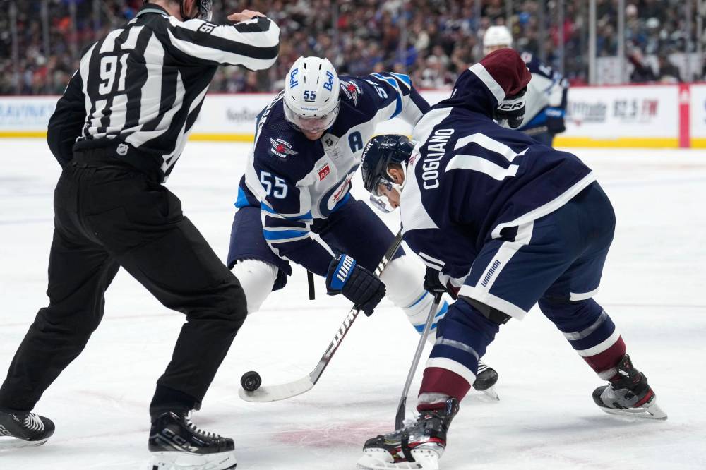 (AP Photo/David Zalubowski)
Winnipeg Jets centre Mark Scheifele and Colorado Avalanche centre Andrew Cogliano face off in the second period.