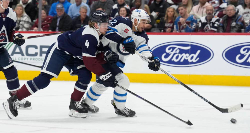 (AP Photo/David Zalubowski)
Winnipeg Jets right wing Nino Niederreiter shoots the puck next to Colorado Avalanche defenceman Bowen Byram during the second period.