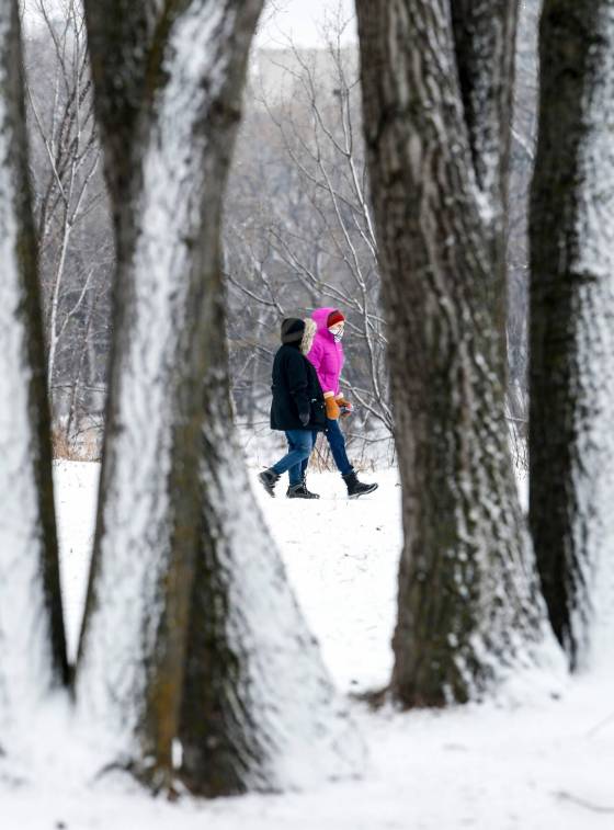 People walk in Elzear-Goulet Memorial Park Sunday. (John Woods / Winnipeg Free Press)