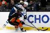 Winnipeg Jets center Adam Lowry (17) gets to the puck before Anaheim Ducks defenseman Radko Gudas (7) during the third period of an NHL hockey game in Anaheim, Calif., Sunday, Dec. 10, 2023. (Alex Gallardo / The Associated Press)