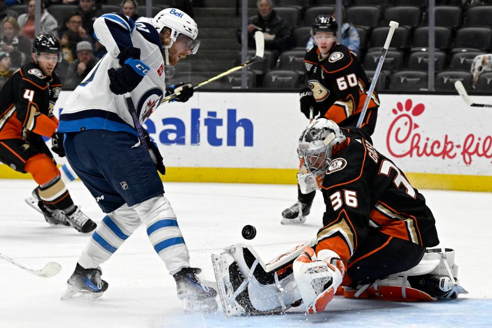 Anaheim Ducks goaltender John Gibson, right, deflects a shot by Winnipeg Jets left wing Kyle Connor during the first period. (Alex Gallardo / The Associated Press)