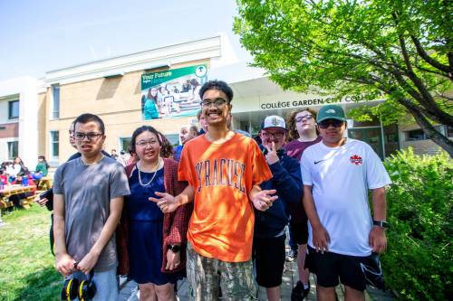 Orion Remoquillo, a grade 12 student who volunteers with students with special needs (centre, orange shirt), poses for a photo with some of the students he volunteers with at Garden City Collegiate. (Mikaela MacKenzie / Winnipeg Free Press files)